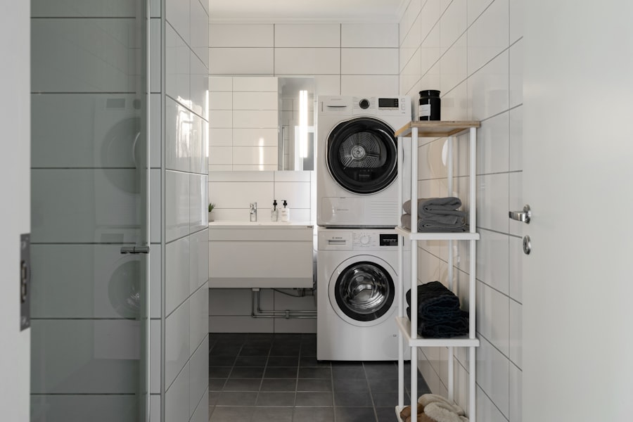 Stacked washer and dryer in a tiled laundry room